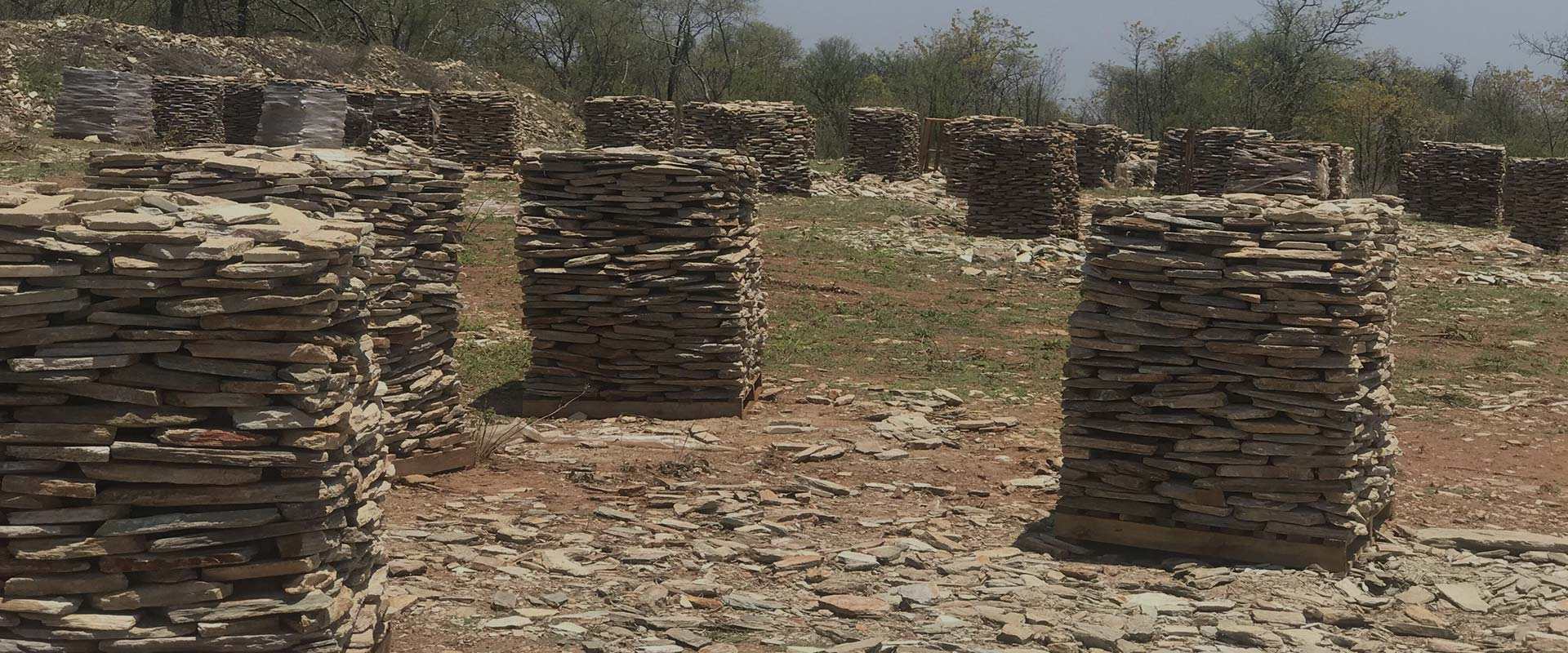 Pallets of split natural stone stacked in rows at the quarry, ready for dispatch