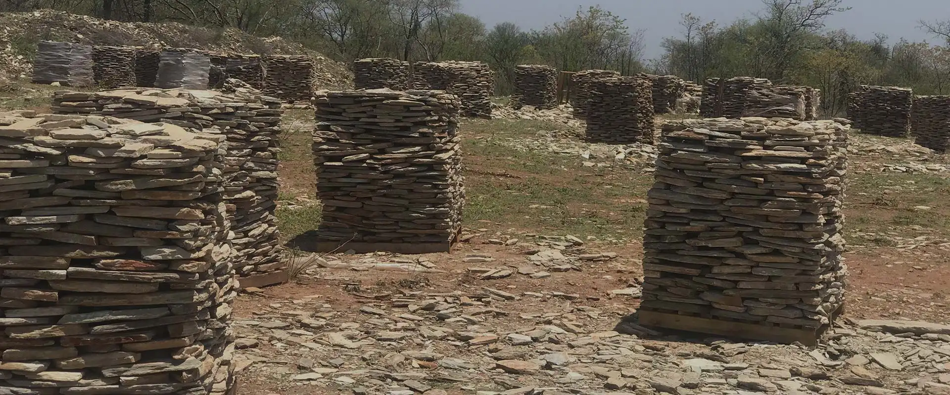 Pallets of split natural stone stacked in rows at the quarry, ready for dispatch